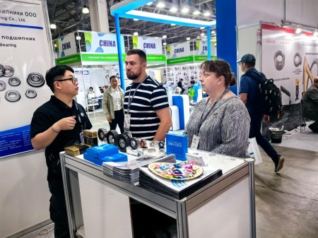 Visitors communicating with the CUKU team at the booth.jpg