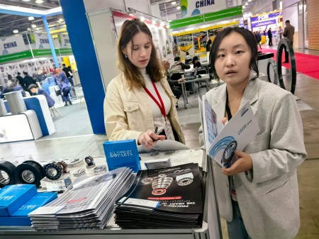 Visitors communicating with the CUKU team at the booth.jpg