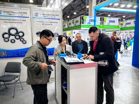 Visitors communicating with the CUKU team at the booth.jpg